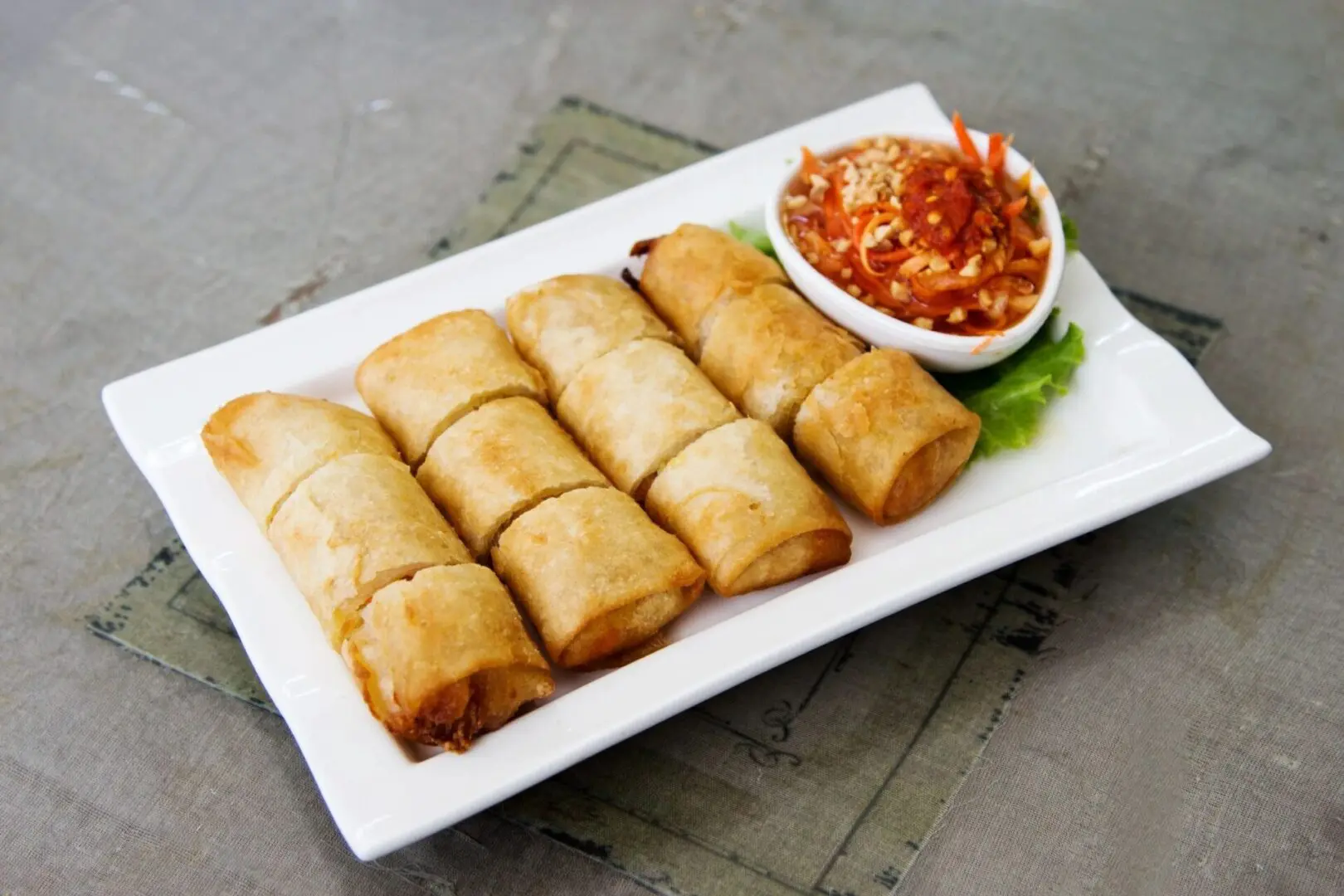 Crispy spring roll on white plate